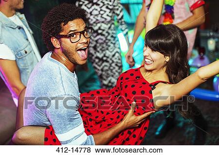 Couple dancing together at party View Large Photo Image Stock Photo - Couple dancing together at party. Fotosearch
