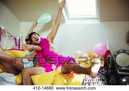 Couple having party in bedroom View Large Photo Image Stock Image - Couple having party in bedroom. Fotosearch