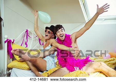 Couple having party in bedroom View Large Photo Image Stock Image - Couple having party in bedroom. Fotosearch