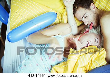 Couple playing in bed with balloons View Large Photo Image Picture - Couple playing in bed with balloons. Fotosearch