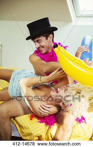 Couple playing together on bed View Large Photo Image Stock Photo - Couple playing together on bed. Fotosearch