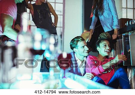 Couple sitting together at party View Large Photo Image Picture - Couple sitting together at party. Fotosearch