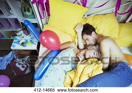 Couple sleeping in bed after party View Large Photo Image Stock Photography - Couple sleeping in bed after party. Fotosearch