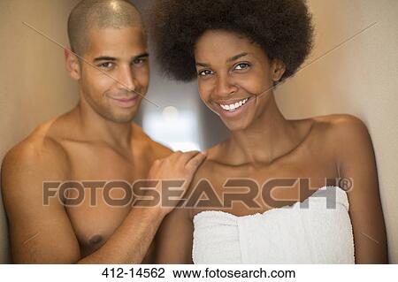 Stock Image - Couple smiling together in bathroom. Fotosearch
