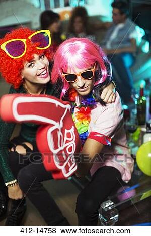 Stock Photo - Couple wearing costumes at party. Fotosearch