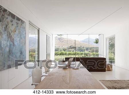 Stock Image - Desk and chairs in modern living space. Fotosearch