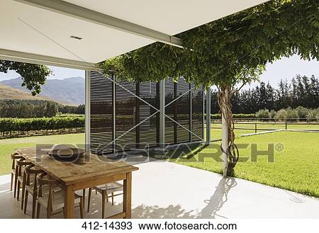 Dining table and chairs on patio overlooking vineyard View Large Photo Image Stock Image - Dining table and chairs on patio overlooking vineyard. Fotosearch
