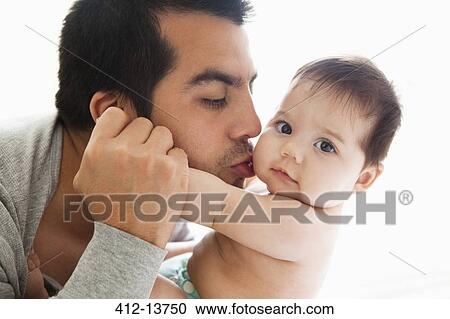 Stock Image - Father kissing baby girl. Fotosearch