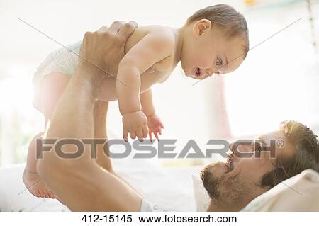 Father playing with baby boy View Large Photo Image Stock Photography - Father playing with baby boy. Fotosearch