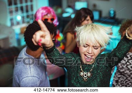 Picture - Friends dancing together at party. Fotosearch