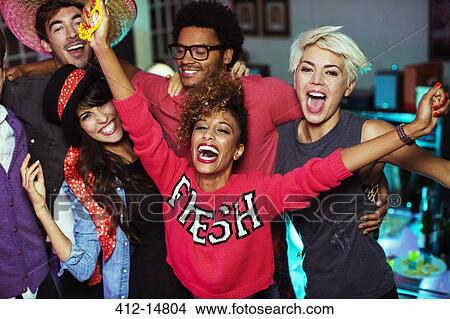 Picture - Friends dancing together at party. Fotosearch