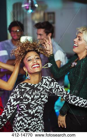 Friends dancing together at party View Large Photo Image Stock Image - Friends dancing together at party. Fotosearch