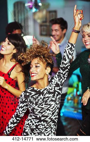 Friends dancing together at party View Large Photo Image Stock Image - Friends dancing together at party. Fotosearch