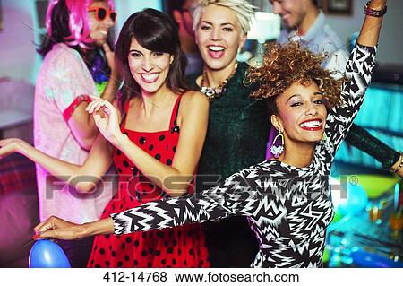 Friends dancing together at party View Large Photo Image Stock Photo - Friends dancing together at party. Fotosearch