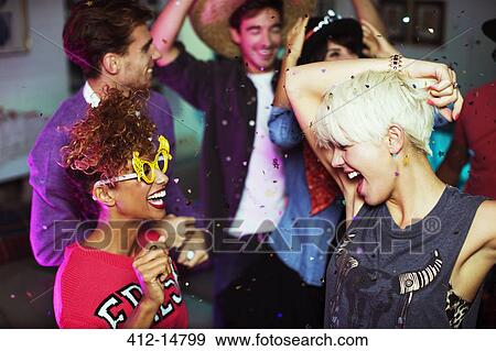 Stock Photo - Friends dancing together at party. Fotosearch