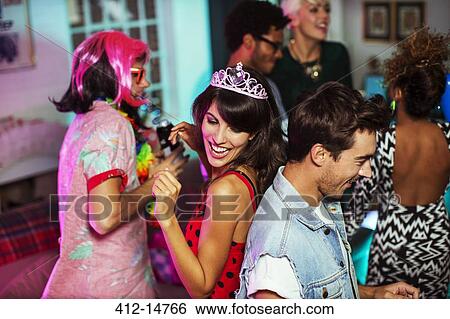 Friends dancing together at party View Large Photo Image Stock Photograph - Friends dancing together at party. Fotosearch