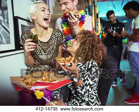 Friends eating pizza at party View Large Photo Image Stock Photography - Friends eating pizza at party. Fotosearch