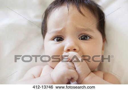 Fussy baby girl sucking her thumb View Large Photo Image Stock Photograph - Fussy baby girl sucking her thumb. Fotosearch