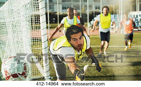 Picture - Goalie training on soccer field. Fotosearch