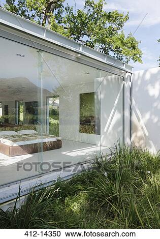 Grass growing outside window of modern bedroom View Large Photo Image Stock Image - Grass growing outside window of modern bedroom. Fotosearch