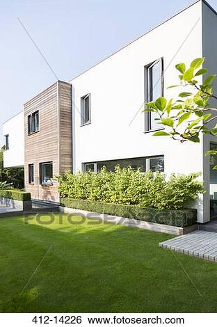 Stock Photograph - Hedges and plants around modern house. Fotosearch