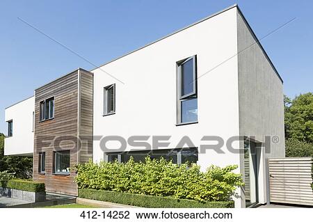 Stock Image - Hedges around modern house. Fotosearch