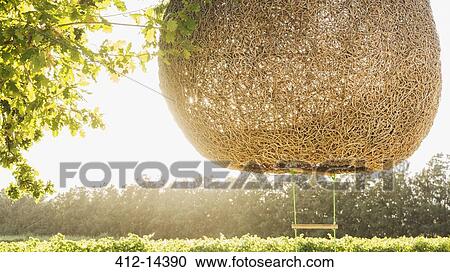 Stock Image - Ladder hanging from nest tree house. Fotosearch