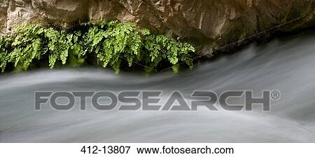 Stock Photo - Long exposure of rushing water. Fotosearch