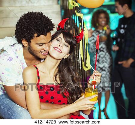 Man hugging girlfriend at party View Large Photo Image Stock Photo - Man hugging girlfriend at party. Fotosearch