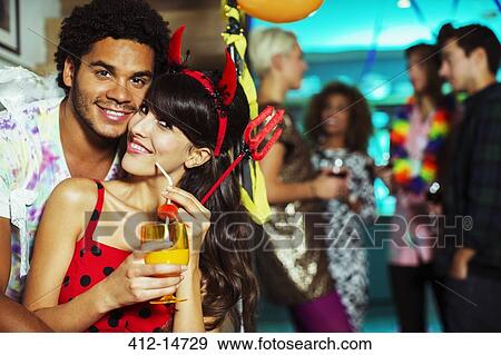 Man hugging girlfriend at party View Large Photo Image Stock Photo - Man hugging girlfriend at party. Fotosearch