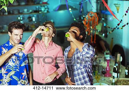 Men taking shots at party View Large Photo Image Stock Image - Men taking shots at party. Fotosearch