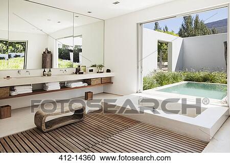 Modern bathroom overlooking luxury soaking pool View Large Photo Image Stock Image - Modern bathroom overlooking luxury soaking pool. Fotosearch