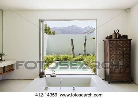 Modern bathroom overlooking luxury soaking pool View Large Photo Image Stock Photo - Modern bathroom overlooking luxury soaking pool. Fotosearch
