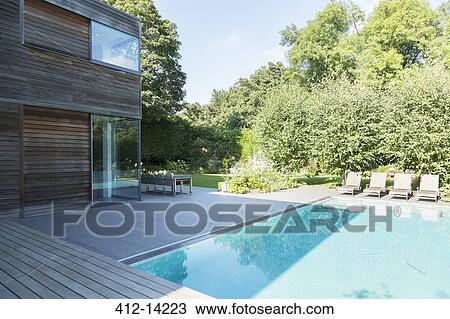 Stock Image - Modern house and swimming pool. Fotosearch