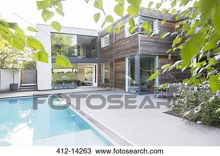 Stock Image - Modern house with swimming pool. Fotosearch
