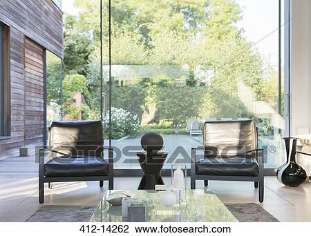 Modern living room overlooking swimming pool View Large Photo Image Stock Image - Modern living room overlooking swimming pool. Fotosearch