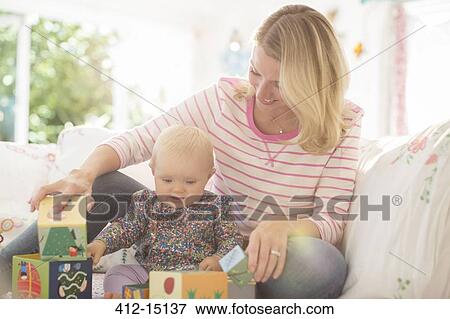 Mother and baby girl playing with blocks View Large Photo Image Stock Photo - Mother and baby girl playing with blocks. Fotosearch