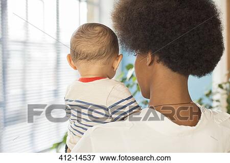 Stock Photo - Mother holding baby boy. Fotosearch