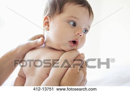 Stock Image - Mother holding baby girl. Fotosearch