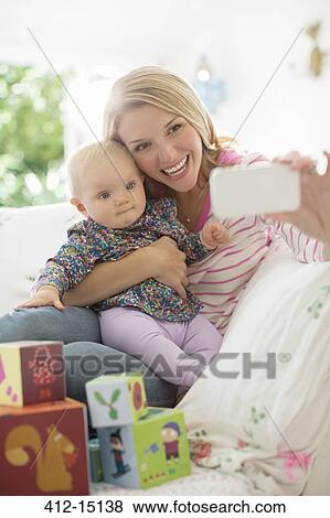 Mother taking self-portrait with baby girl View Large Photo Image Stock Photo - Mother taking self-portrait with baby girl. Fotosearch