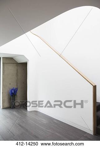 Stock Image - Painting along staircase of modern house. Fotosearch
