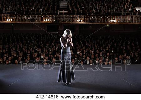 Performer with head in hands on stage in theater View Large Photo Image Stock Photograph - Performer with head in hands on stage in theater. Fotosearch