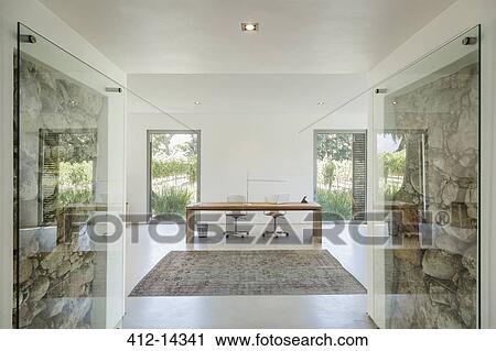Rocks behind glass in wall of modern home office View Large Photo Image Stock Image - Rocks behind glass in wall of modern home office. Fotosearch