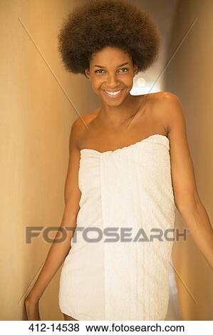 Stock Photo - Smiling woman wrapped in a towel. Fotosearch