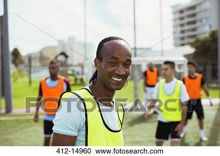 Stock Image - Soccer player smiling on field. Fotosearch