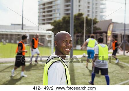 Soccer player smiling on field View Large Photo Image Stock Image - Soccer player smiling on field. Fotosearch