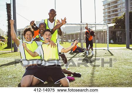 Soccer players cheering on field View Large Photo Image Stock Photography - Soccer players cheering on field. Fotosearch