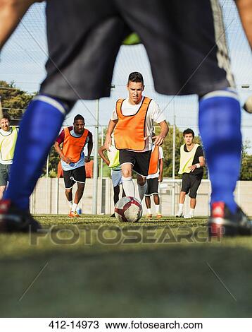 Stock Image - Soccer players training on field. Fotosearch
