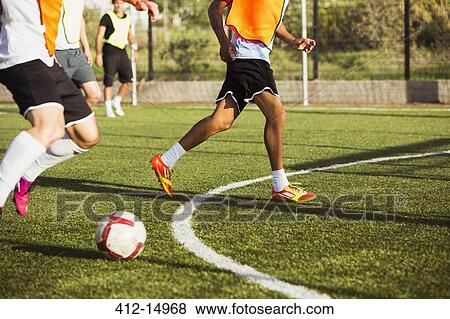Stock Photo - Soccer players training on field. Fotosearch