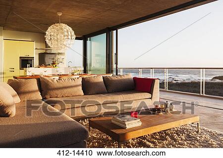 Sofa and coffee table in modern living room overlooking ocean View Large Photo Image Stock Image - Sofa and coffee table in modern living room overlooking ocean. Fotosearch